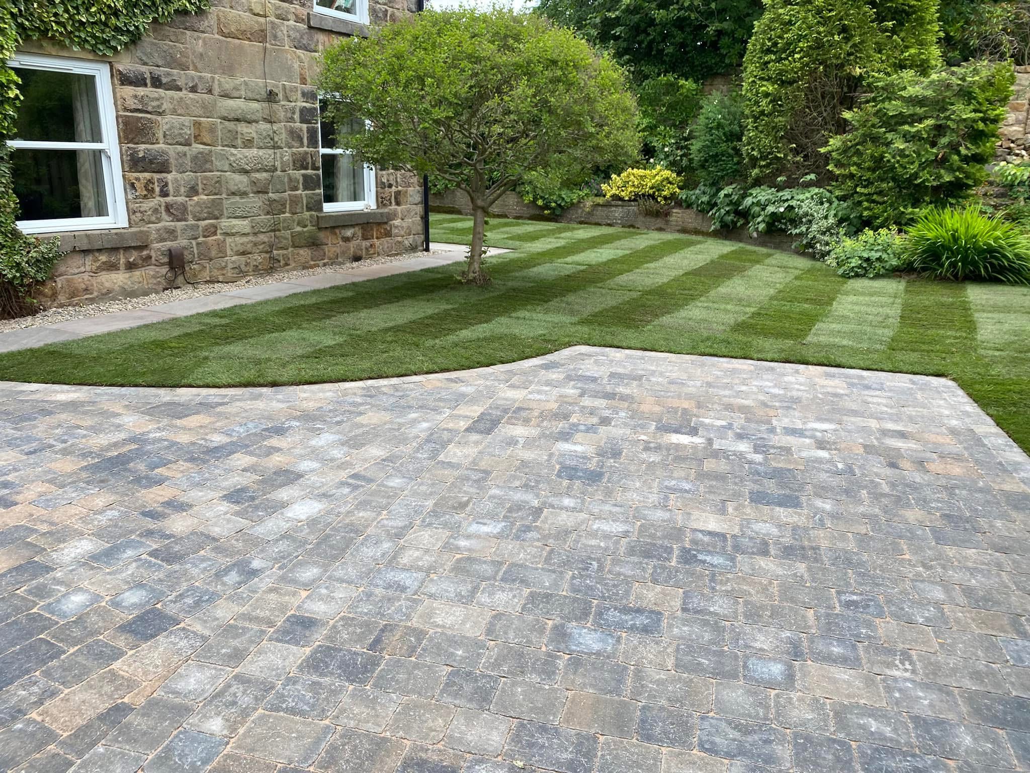 Block paving with manicured lawn